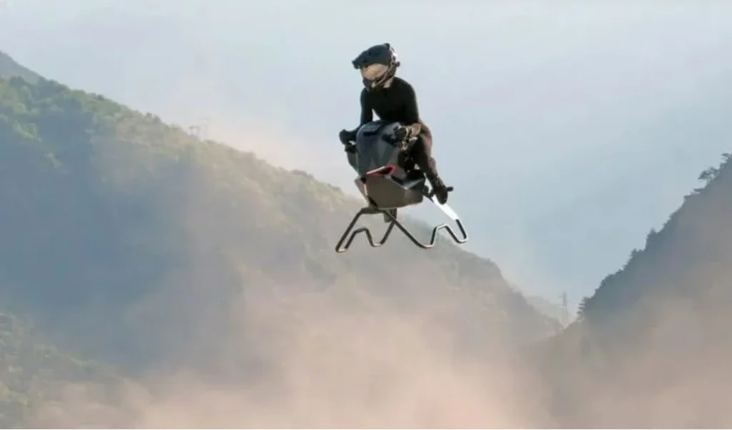 Volonaut Airbike flying above a cityscape during sunset