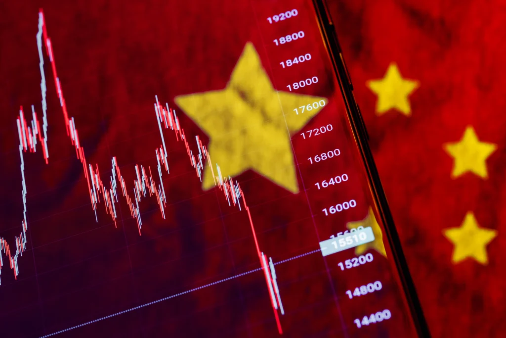 U.S. and Chinese flags facing off over cargo containers, symbolizing the trade war