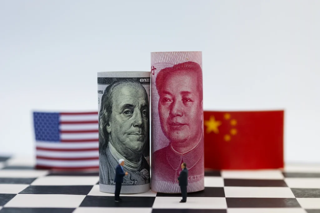 U.S. and Chinese flags facing off over cargo containers, symbolizing the trade war