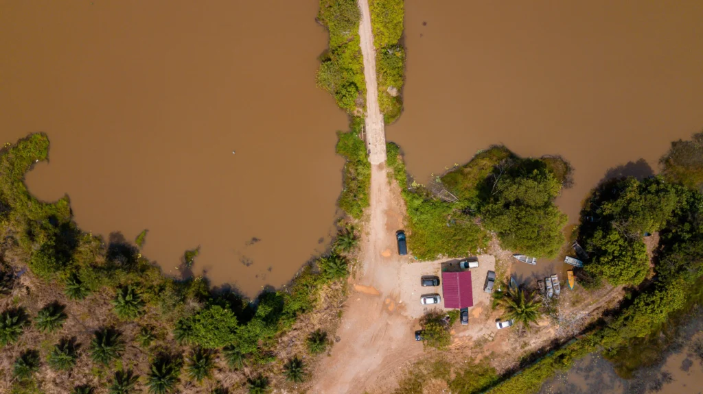 Flooded street near Guadalupe River with emergency responders assisting evacuees during 2025 flood.