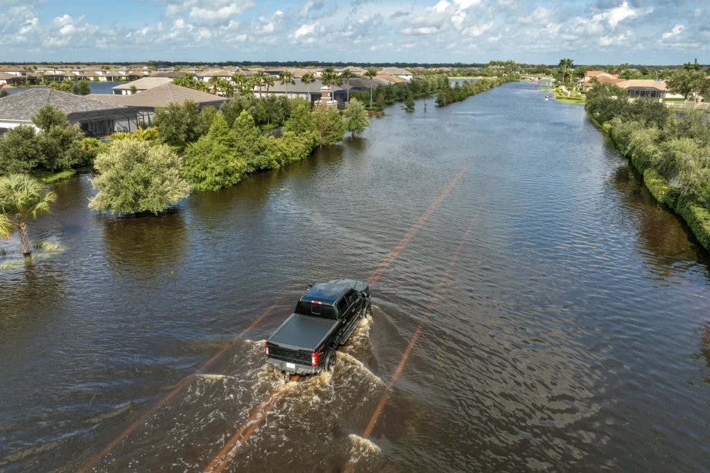 guadalupe river flooding
Flooded street near Guadalupe River with emergency responders assisting evacuees during 2025 flood.