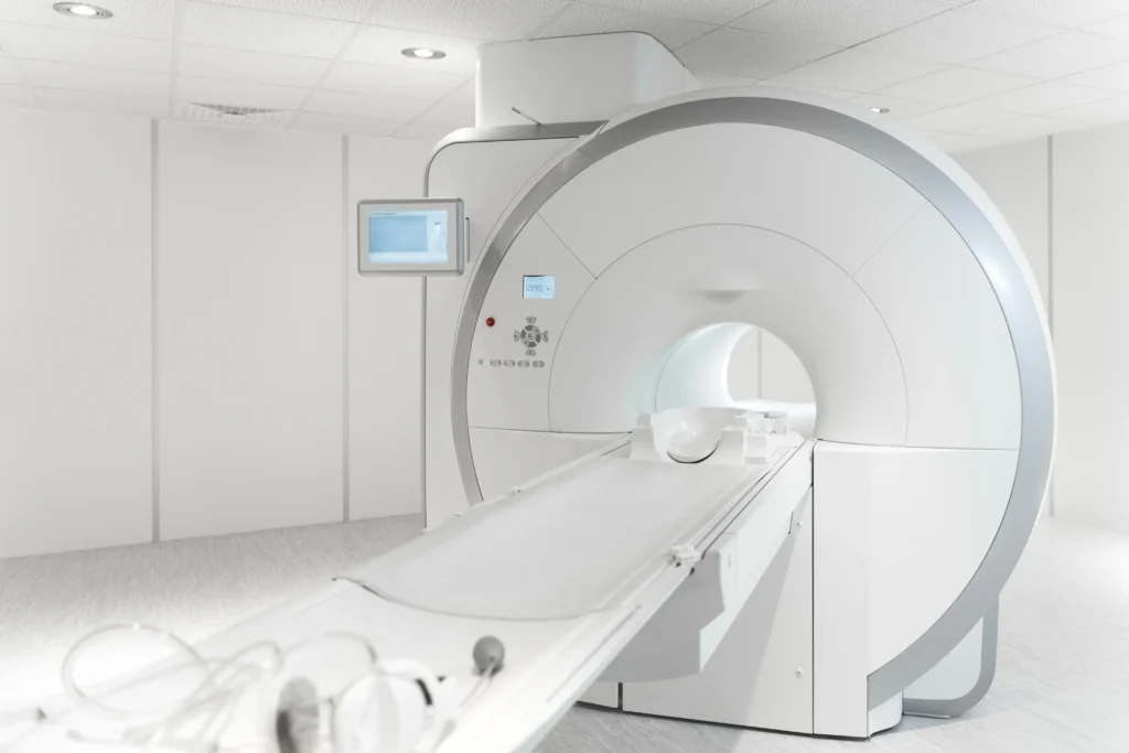 MRI machine in a hospital room with safety warning signs