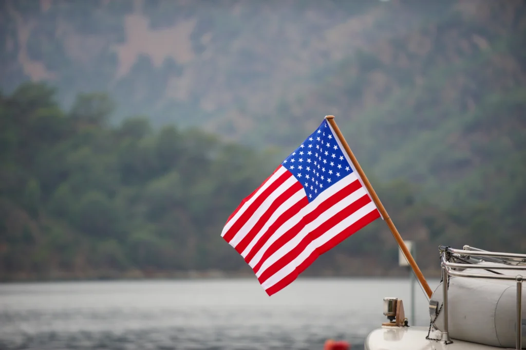 Coast Guard Day, August 4th, with a U.S. Coast Guard cutter patrolling at sea.