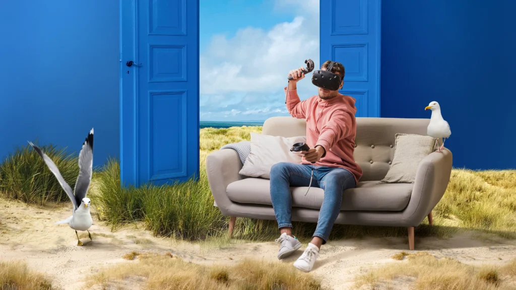 A young man experiences virtual travel at home with a VR headset, exploring landmarks like Mount Fuji, the Eiffel Tower, and the Pyramids of Giza.