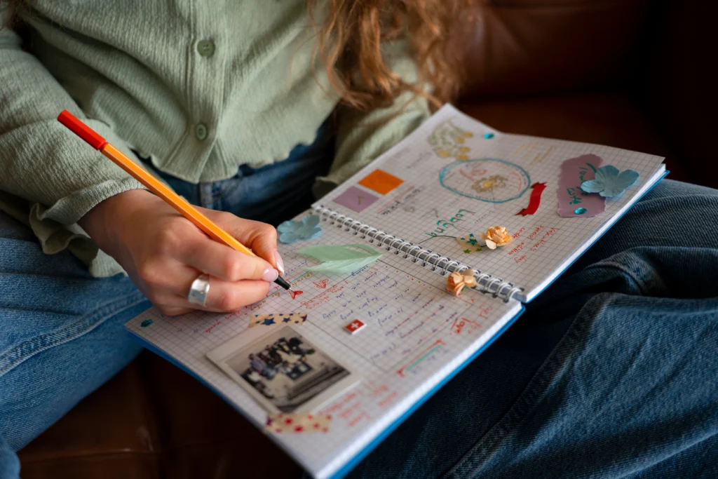 Person journaling at a desk, practicing mindfulness and writing for mental clarity