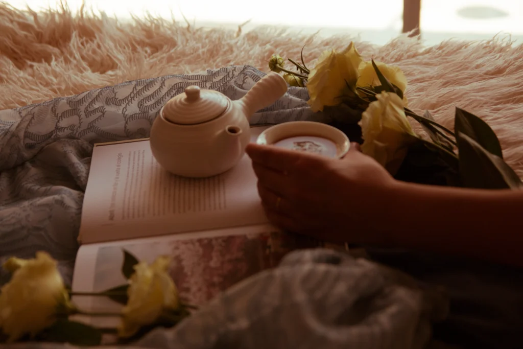 A woman enjoying a quiet morning with coffee and sunlight, symbolizing the art of slow living and mindfulness.