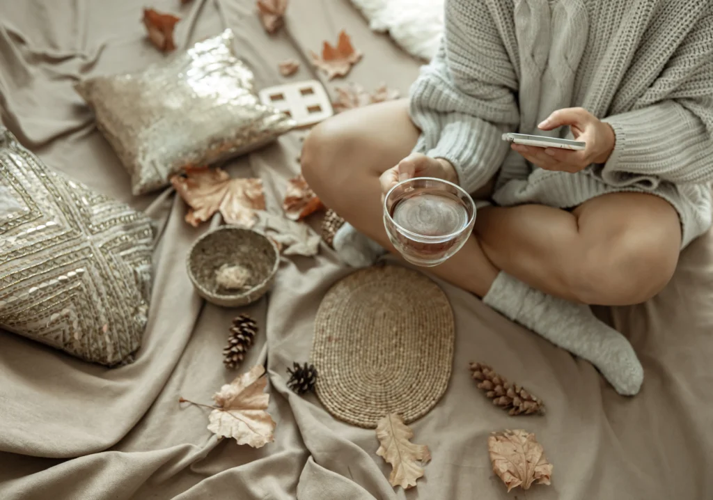A woman enjoying a quiet morning with coffee and sunlight, symbolizing the art of slow living and mindfulness.