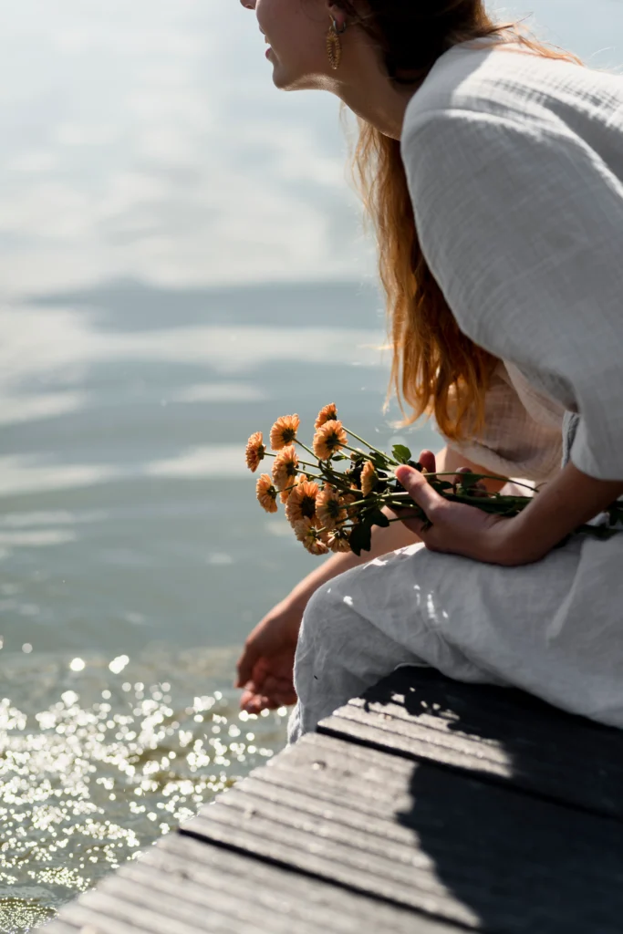 A woman enjoying a quiet morning with coffee and sunlight, symbolizing the art of slow living and mindfulness.