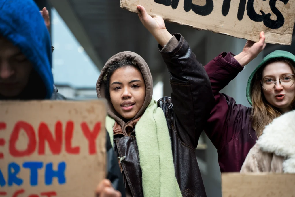Activism of Young Americans
Young Americans holding protest signs during a peaceful rally, marching in a U.S. city to advocate for climate justice and social equality.