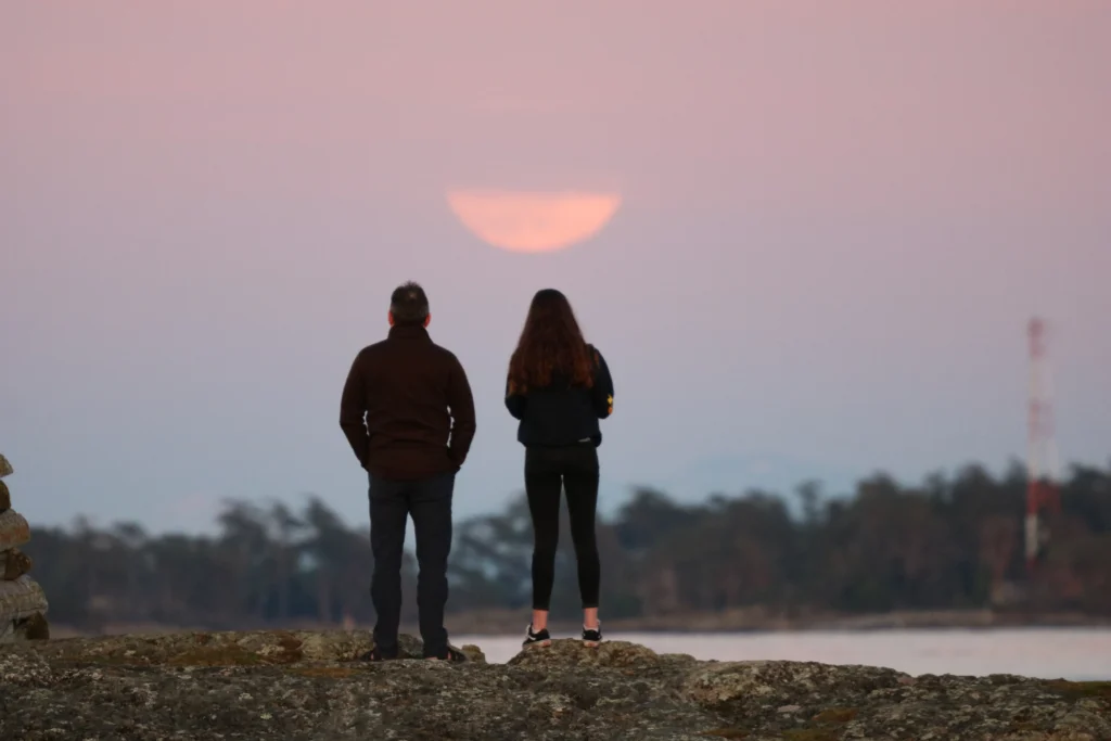 Beaver Moon rising over a serene landscape, casting a soft glow on the horizon