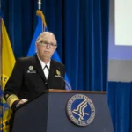 Admiral Rachel Levine speaking at a public event, highlighting challenges of institutional deadnaming