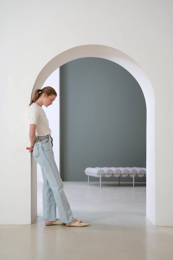 Minimalist modern living space with neutral colors, simple furniture, and natural light creating a calm, clutter-free atmosphere.