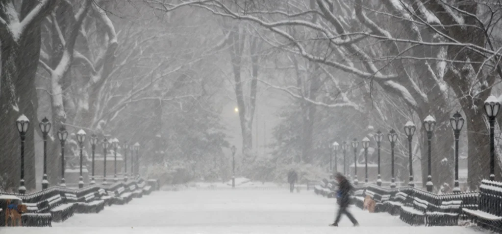 Historic winter storm covering U.S. cities with heavy snow, icy roads, and frozen landscapes