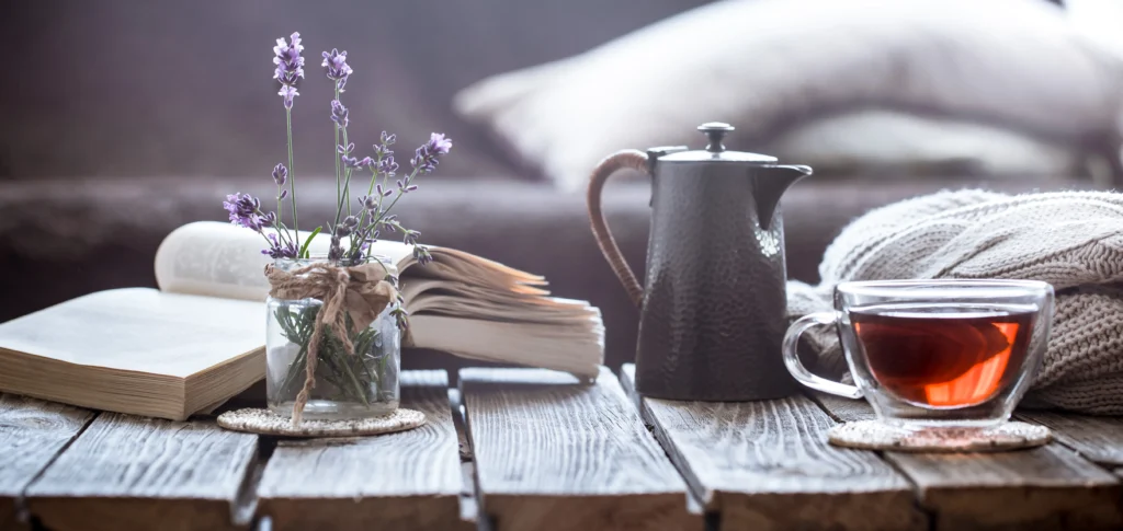 The Art of Slow Living
Person enjoying a peaceful slow living moment at home, surrounded by natural light, plants, and simple decor, reflecting a calm and intentional lifestyle.
