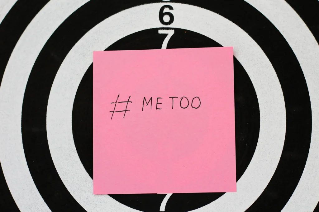 the #MeToo Movement protest with people holding signs, symbolizing the fight against sexual harassment and empowering survivors in Hollywood and beyond.