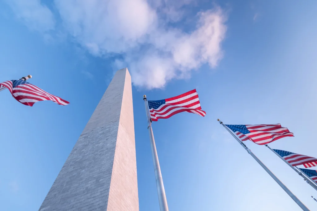 U.S. Capitol under dramatic clouds symbolizing concerns over the Insurrection Act and potential threats to democracy in 2026.
