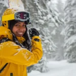 Skier wearing a helmet and carrying a first aid kit, ready for skiing safely