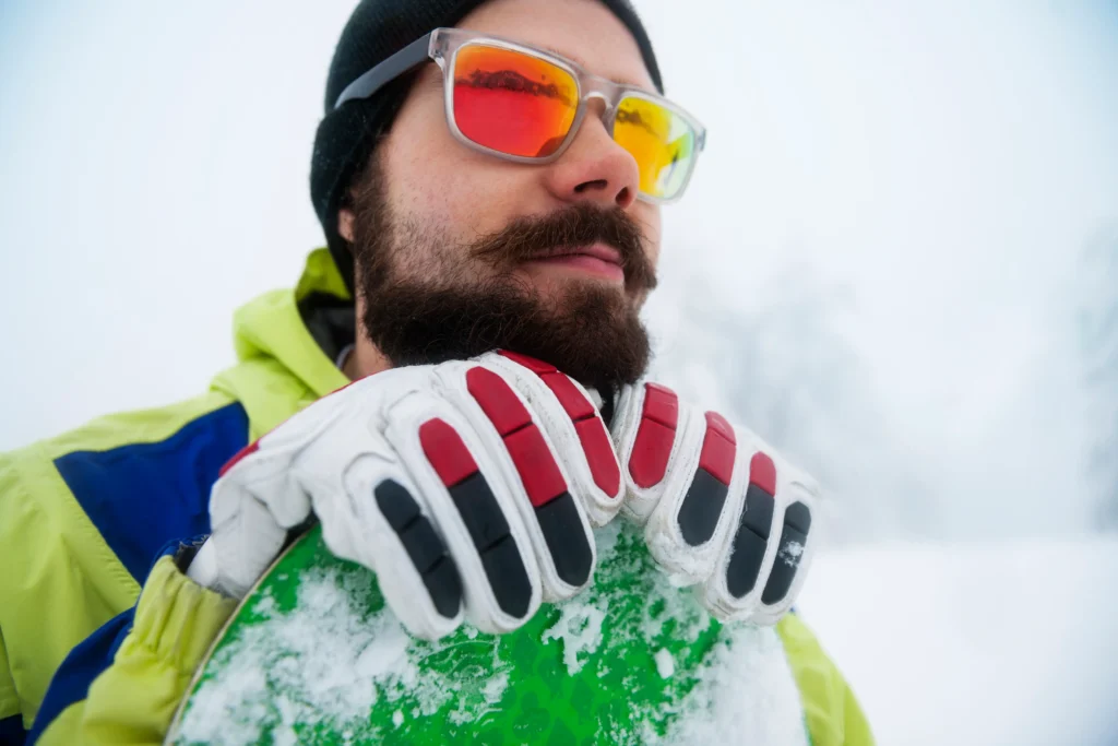 Skiers wearing helmets and proper gear on a snowy slope, practicing ski safety