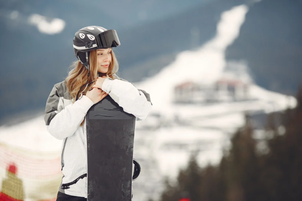 Skiers wearing helmets and proper gear on a snowy slope, practicing ski safety