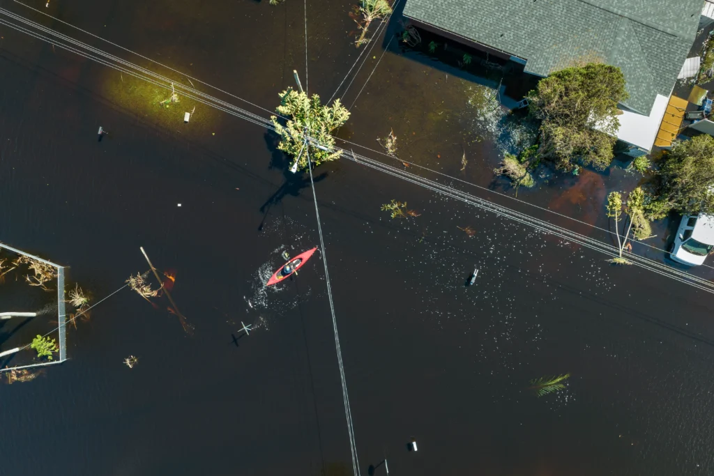 Flooded street in Oahu, Hawaii, with emergency rescue operations underway during severe flash flooding.