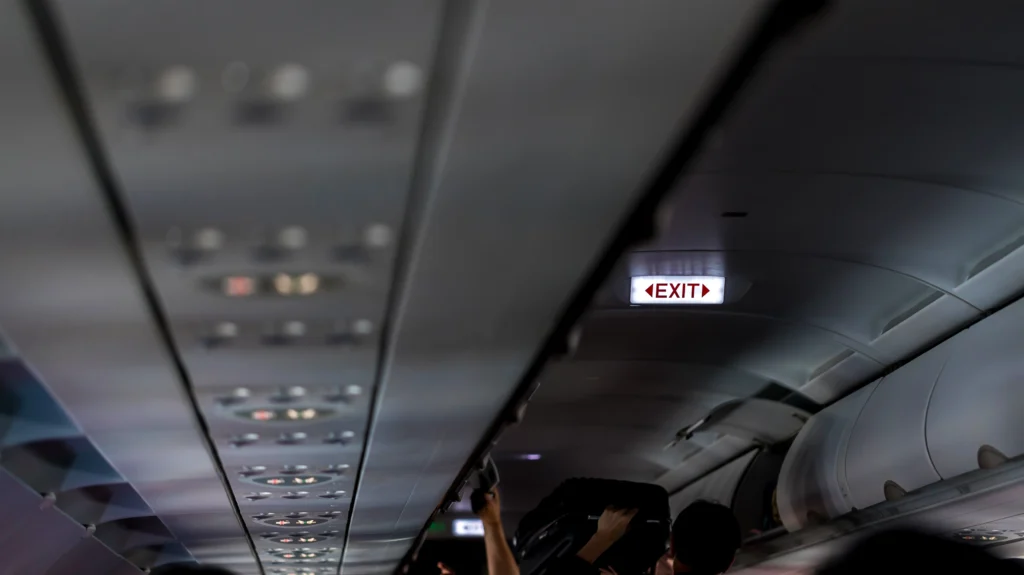 Delta Airlines counter with VIP signage and passengers in line, highlighting suspension of congressional perks