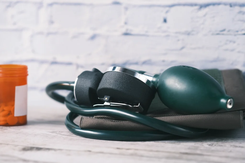 Person holding their chest while laughing and coughing, symbolizing concerns about high blood pressure triggers