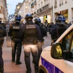 Police and emergency responders at the scene of a shooting in downtown Bloomington, Indiana near the university area at night