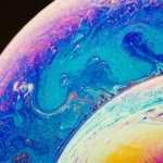 iPhone displaying iOS 26.5 update features including messaging, Apple Maps, and new wallpapers
