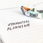 A person managing personal finances with a laptop, calculator, and budget planning notes on a desk representing financial discipline and money management