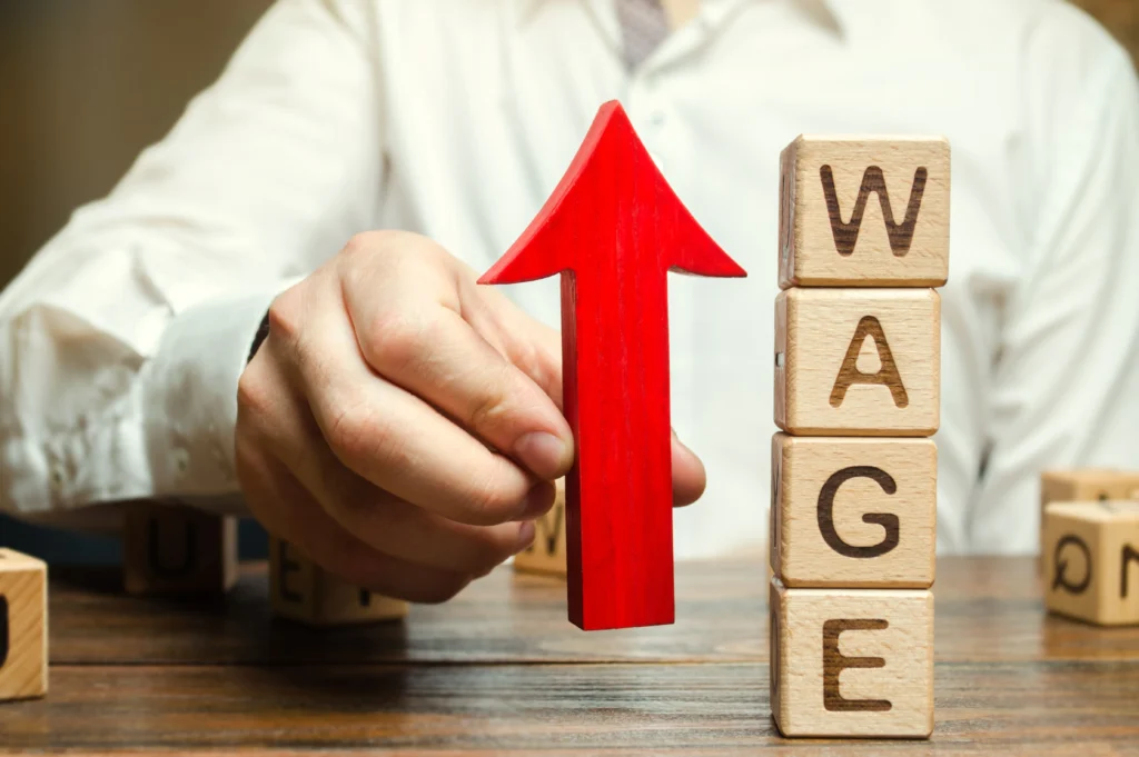 U.S. workers and policymakers discussing the 2026 minimum wage increase debate