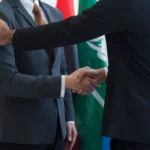 Delegates from the United States and Iran meeting in Switzerland during diplomatic talks, symbolizing rising global tensions and international negotiations.