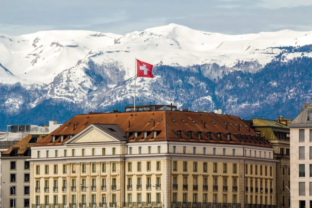 Delegates from the United States and Iran meeting in Switzerland during diplomatic talks, symbolizing rising global tensions and international negotiations.