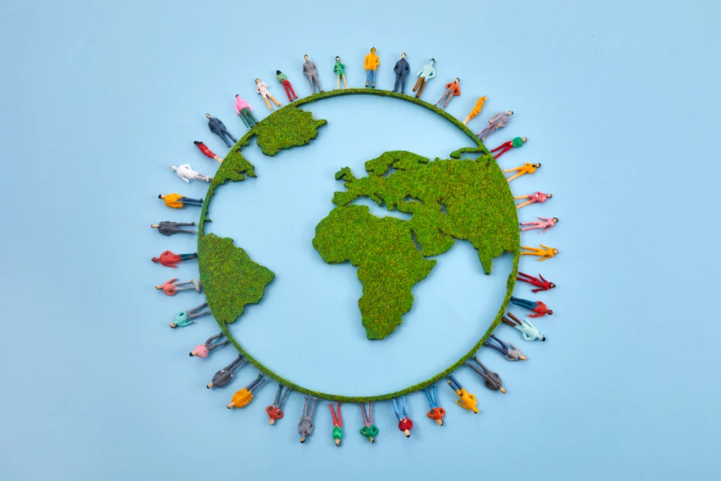Infographic illustrating the decline in fertility rates worldwide with a graph showing falling birth rates and diverse families in the background.