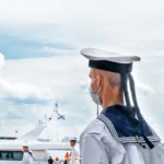 U.S. Navy officers standing on a ship deck symbolizing military leadership and promotion decisions