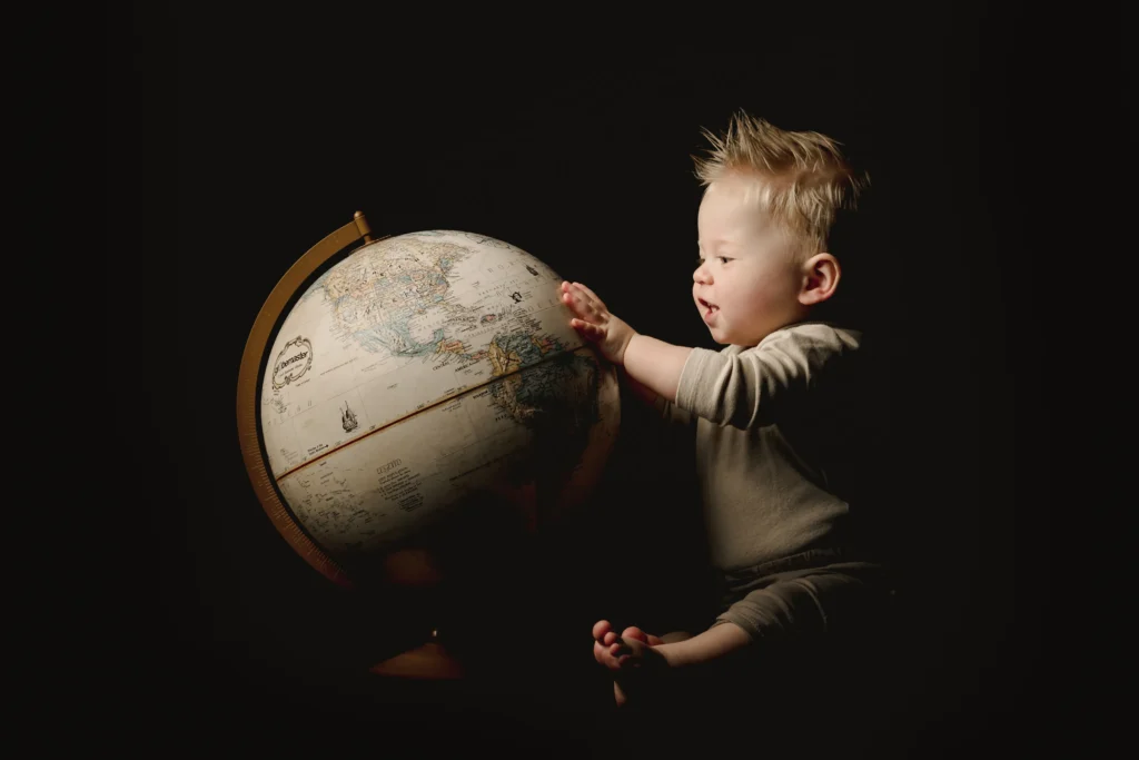 Infographic illustrating the decline in fertility rates worldwide with a graph showing falling birth rates and diverse families in the background.