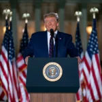 President Donald Trump delivers his July 4 speech during America's 250th Independence Day celebration in Washington, D.C., with fireworks lighting up the night sky behind him.