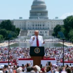 Donald Trump displaying a Trump 2028 hat while joking about another presidential campaign.