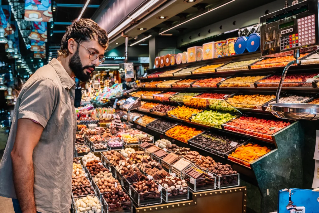 Zohran Mamdani speaks at a public event while defending his proposal for low-cost city-run grocery stores, highlighting efforts to help New Yorkers cope with rising food prices and the cost-of-living crisis.